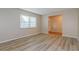 Living room with light-colored walls, a window, and wood-look floors at 2006 Sycamore Ln, Plant City, FL 33563