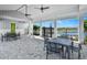 Outdoor seating area with tables, chairs, ceiling fans, and views of the community lake at 28875 Seedling St, Wesley Chapel, FL 33543