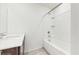 Bright, clean bathroom features a shower-tub combo and single sink with wood-look flooring at 5329 Companion Ln, Tampa, FL 33619