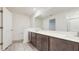 Bright bathroom with double vanity and large mirror at 5329 Companion Ln, Tampa, FL 33619