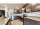 Modern kitchen features stainless steel appliances, granite countertops, and dark cabinetry at 5329 Companion Ln, Tampa, FL 33619