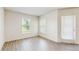 Bright living room with wood floors featuring a door to the outside with light streaming through at 5329 Companion Ln, Tampa, FL 33619