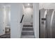 Carpeted staircase leading upstairs to other rooms and a door to a bathroom at 1332 W Gray St # 6, Tampa, FL 33606