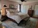 Serene main bedroom featuring a king bed with a plush rug, warm lighting, and ample closet space at 4419 Waltham Dr, Tampa, FL 33634