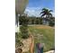 Well-maintained backyard with waterfront access and lush tropical landscaping and rock bed at 8252 Tecumseh Cir, Port Charlotte, FL 33981