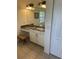 Bright bathroom vanity area features a granite countertop and storage cabinets with white trim at 8252 Tecumseh Cir, Port Charlotte, FL 33981