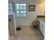 Bright bathroom vanity area features a granite countertop and storage cabinets with white trim at 8252 Tecumseh Cir, Port Charlotte, FL 33981