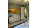 Tranquil bedroom featuring tiled floors, a dresser with an ornate mirror and views into an adjoining room at 8252 Tecumseh Cir, Port Charlotte, FL 33981