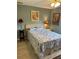 Cozy bedroom with blue walls, a comfortable bed, matching lamps, and stylish artwork at 8252 Tecumseh Cir, Port Charlotte, FL 33981