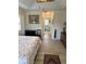 Bedroom featuring light hardwood flooring, a ceiling fan, and entry into an en suite bathroom at 8252 Tecumseh Cir, Port Charlotte, FL 33981
