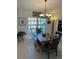 Warm dining room boasts a rustic table, a bench, and a stylish chandelier overhead at 8252 Tecumseh Cir, Port Charlotte, FL 33981