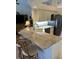 Kitchen featuring stainless steel appliances, light countertops, and barstool seating at 8252 Tecumseh Cir, Port Charlotte, FL 33981