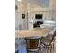 Kitchen boasts light countertops, wood cabinets, black appliances, and bar stool seating at 8252 Tecumseh Cir, Port Charlotte, FL 33981