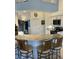 Kitchen with bar seating, light countertops, stainless steel sink, and black appliances at 8252 Tecumseh Cir, Port Charlotte, FL 33981