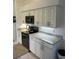 Bright kitchen showcases light-colored cabinets, black appliances, and modern finishes at 8252 Tecumseh Cir, Port Charlotte, FL 33981