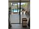 Lanai with sliding glass doors leading to pool, plants, bar seating, and adjacent canal at 8252 Tecumseh Cir, Port Charlotte, FL 33981