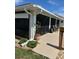 Covered patio with outdoor seating, offering a serene view of the landscaped yard at 8252 Tecumseh Cir, Port Charlotte, FL 33981