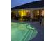 Well-lit backyard pool area at night, perfect for a refreshing evening swim at 8252 Tecumseh Cir, Port Charlotte, FL 33981