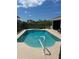 Relaxing backyard pool perfect for cooling off on hot days, complete with a playful swan float at 8252 Tecumseh Cir, Port Charlotte, FL 33981