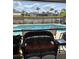 Inviting outdoor space with pool, waterfront views, and comfortable seating on screened patio at 8252 Tecumseh Cir, Port Charlotte, FL 33981