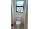 Cozy powder room is designed with a decorative frosted window and tiled flooring at 8252 Tecumseh Cir, Port Charlotte, FL 33981