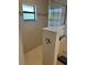 Tiled shower area with glass partition, shower head, and window at 8252 Tecumseh Cir, Port Charlotte, FL 33981