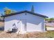 Back of home featuring an exterior door and the home's AC unit at 9235 Richwood Ln, Port Richey, FL 34668