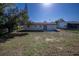 View of backyard with small patio, grassy area, and partial fence at 9235 Richwood Ln, Port Richey, FL 34668