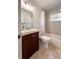 Bright bathroom with a vanity, mirror, toilet, and a tub with a shower at 9235 Richwood Ln, Port Richey, FL 34668