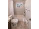 Bathroom featuring a shower and tub combination, complemented by neutral tile and fixtures at 9235 Richwood Ln, Port Richey, FL 34668