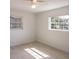 Inviting bedroom with wood-look floors, a ceiling fan, and bright natural light at 9235 Richwood Ln, Port Richey, FL 34668