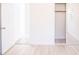 Bedroom with wood-look floors featuring a closet and doorway at 9235 Richwood Ln, Port Richey, FL 34668
