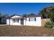 Side view of a well-maintained single-story home with a manicured lawn at 9235 Richwood Ln, Port Richey, FL 34668
