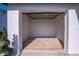 View into a clean, empty single car garage with freshly painted walls at 9235 Richwood Ln, Port Richey, FL 34668