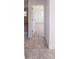 Open hallway featuring light tile flooring, leading into a bright living space at 9235 Richwood Ln, Port Richey, FL 34668