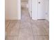 Tile hallway leading into a bathroom, showcasing a clean and modern design at 9235 Richwood Ln, Port Richey, FL 34668