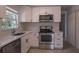 The kitchen features white cabinets and stainless steel appliances at 9235 Richwood Ln, Port Richey, FL 34668