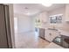 The kitchen features stainless steel appliances and white cabinets at 9235 Richwood Ln, Port Richey, FL 34668