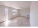 Bright living room featuring tile floors, a window view, and a white front door at 9235 Richwood Ln, Port Richey, FL 34668