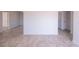 Spacious room with neutral tile flooring and light paint at 9235 Richwood Ln, Port Richey, FL 34668