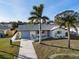 Aerial view of a charming home with manicured lawn and mature palm trees at 105 12Th Sw St, Ruskin, FL 33570