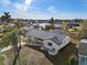 Aerial view of a lakeside property with palm trees, lush landscaping, and stylish single Gathering home at 105 12Th Sw St, Ruskin, FL 33570