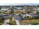 Aerial view of a neighborhood with a lake and single Gathering homes nestled amongst palm trees and lush landscaping at 105 12Th Sw St, Ruskin, FL 33570
