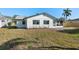 Backyard featuring a new patio, lush lawn, privacy fence, and modern exterior design at 105 12Th Sw St, Ruskin, FL 33570