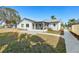 Spacious backyard featuring a screened patio, a well-maintained lawn, and manicured landscaping at 105 12Th Sw St, Ruskin, FL 33570