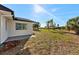 Spacious backyard with palm trees; ample room for outdoor activities and relaxation at 105 12Th Sw St, Ruskin, FL 33570