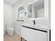 Bathroom featuring a modern vanity, illuminated mirror, and tiled floors at 105 12Th Sw St, Ruskin, FL 33570