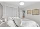 Bright bedroom with white decor and textured wall art, creating a soothing atmosphere at 105 12Th Sw St, Ruskin, FL 33570