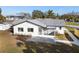 Charming home featuring a screened-in porch, well-maintained yard, and modern exterior design at 105 12Th Sw St, Ruskin, FL 33570