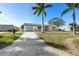 Well-maintained home with blue accents, a long driveway, and freshly landscaped front yard at 105 12Th Sw St, Ruskin, FL 33570